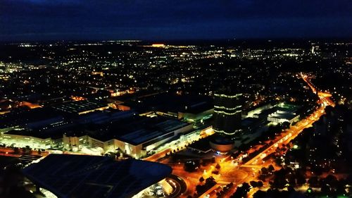 Aerial view of illuminated cityscape against sky at night