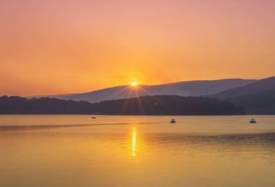 Scenic view of lake against sky during sunset