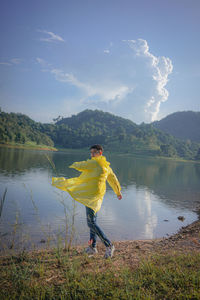 Man walking against lake