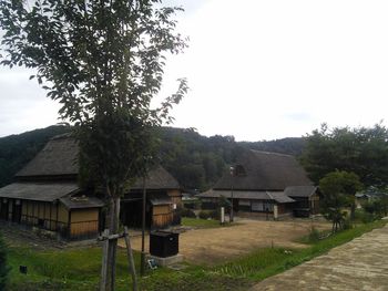 House on field against clear sky