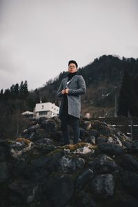 Portrait of young man standing on rock