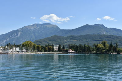 Scenic view of lake and mountains against blue sky