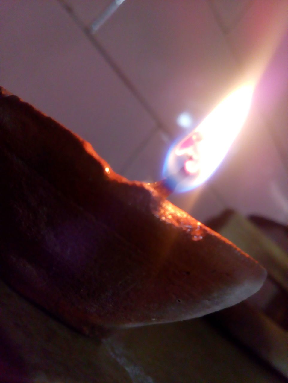 CLOSE-UP OF LIT CANDLE ON STAGE