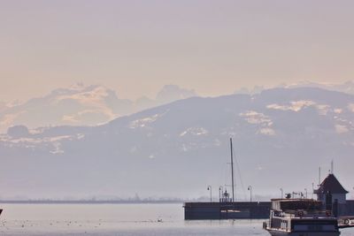 Sailboats in sea against sky