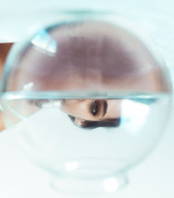Close-up portrait of boy in glass