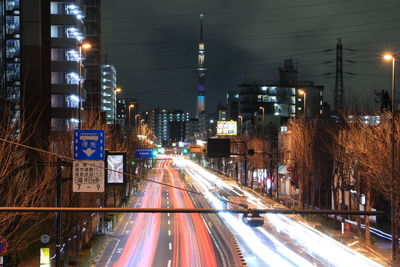 Light trails on road along buildings at night