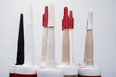 High angle view of colorful bottles against white background