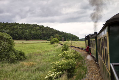 Train on field against sky