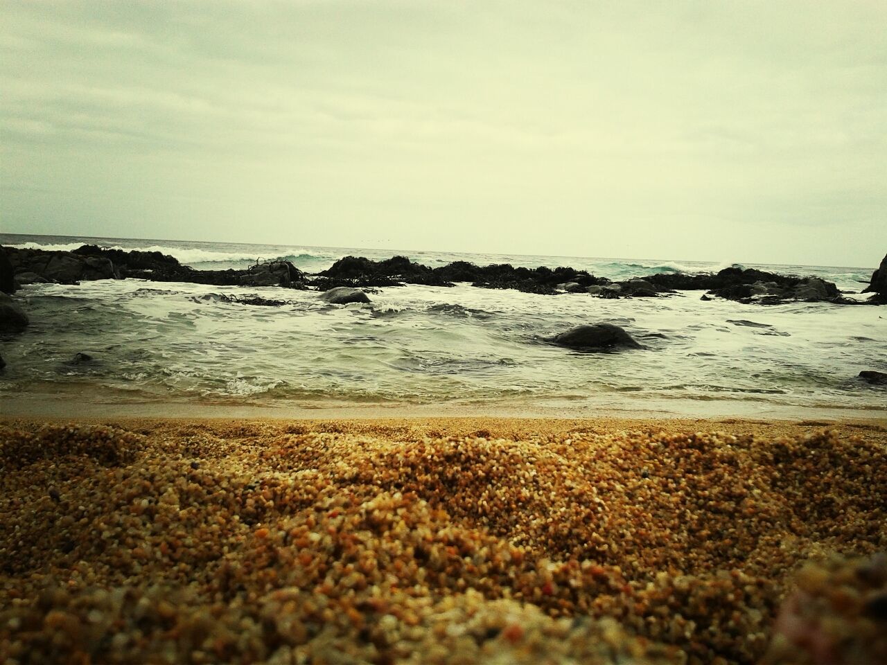 beach, sea, water, shore, sky, horizon over water, tranquil scene, sand, tranquility, scenics, beauty in nature, nature, surface level, rock - object, wave, pebble, stone - object, coastline, idyllic, cloud - sky