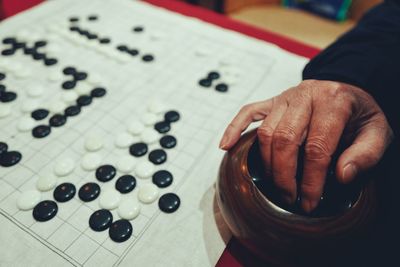 Cropped hand playing board game