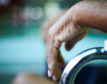 Close-up of hand on wheelchair