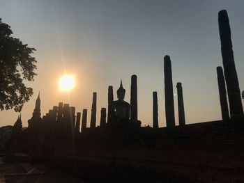 Silhouette of temple against sky during sunset