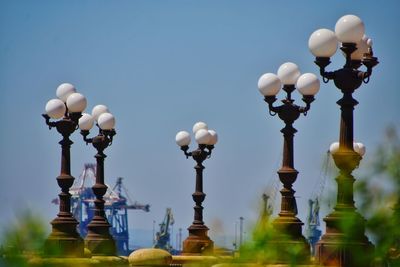 Low angle view of street lights against clear sky