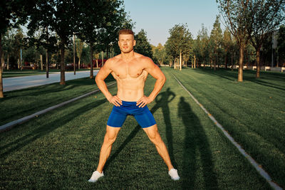 Full length of man exercising on field