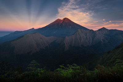 Scenic view of mountain range against sky during sunset