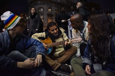 People playing guitar at music concert