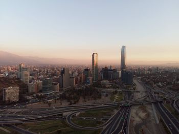 High angle view of street amidst buildings against sky during sunset