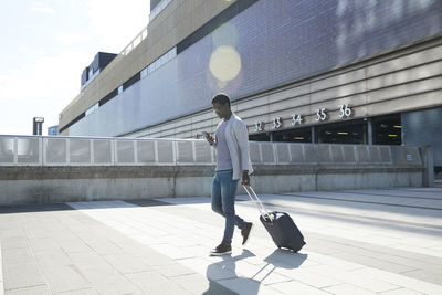 Rear view of man walking on road