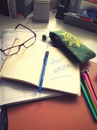 High angle view of paper and book on table