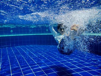 Boy swimming in pool