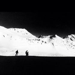 Tourists on snow covered mountain