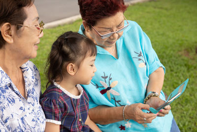 Family using smartphone outdoors