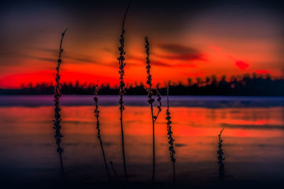 Scenic view of lake against romantic sky at sunset