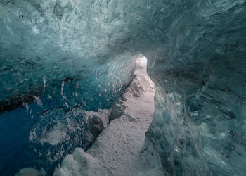 Full frame view through a natural ice tunnel through a glacier