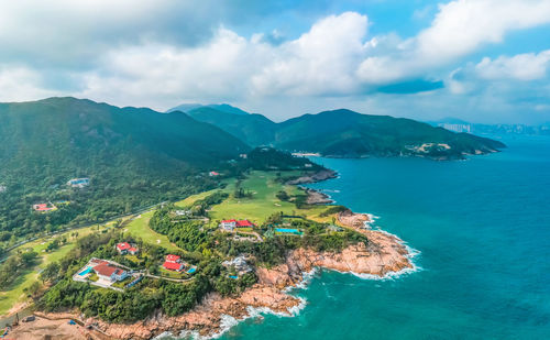 High angle view of sea and mountains against sky