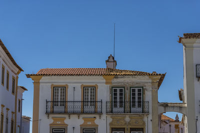 Low angle view of historic building against clear blue sky