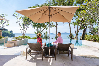 People sitting on chair by table