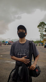 Full length of young man standing on street in city