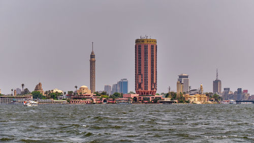 View of buildings in city against clear sky