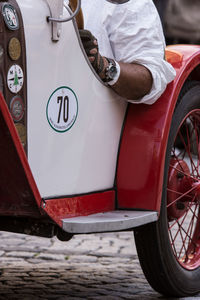 Midsection of man sitting in vintage car