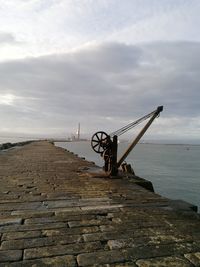 Pier over sea against sky