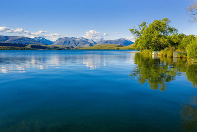 Scenic view of lake against blue sky