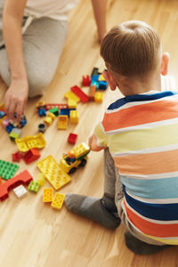 Rear view of boy playing with toys
