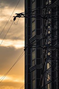 Low angle view of silhouette building against sky during sunset