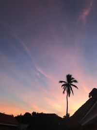 Low angle view of silhouette palm trees against sky during sunset