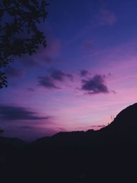Low angle view of silhouette mountain against sky at sunset