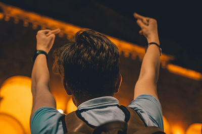 Rear view of friends at illuminated nightclub