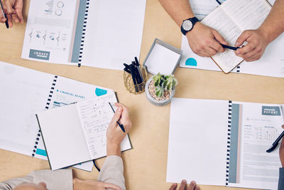 High angle view of business colleagues working on table