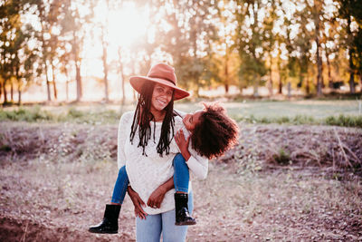 Woman wearing hat while standing on land