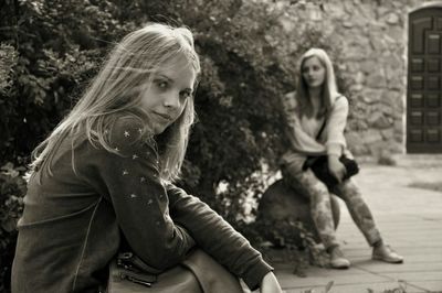 Portrait of girl sitting outdoors