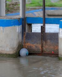 Blue ball on metallic structure against building