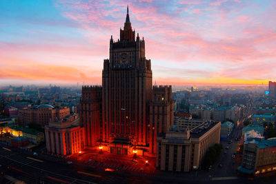 Modern buildings in city during sunset