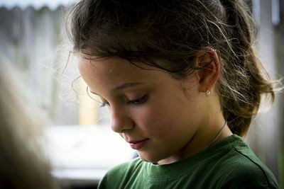 Close-up of cute girl looking away outdoors