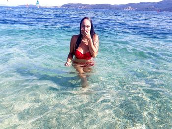 Young woman standing in swimming pool