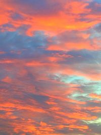 Low angle view of cloudy sky at sunset