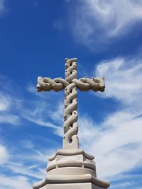 Low angle view of cross against blue sky